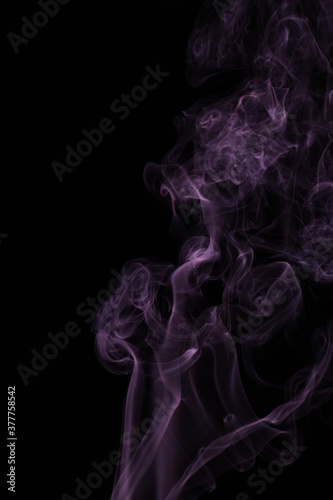 purple smoke from incense on a black background