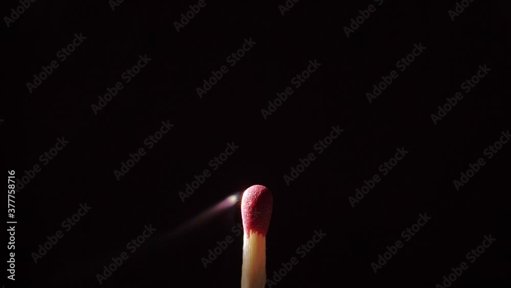 Close up of an isolated Match stick catching fire from start to finish against a black background. Close up of an isolated Match stick catching fire from start to finish against a black background.