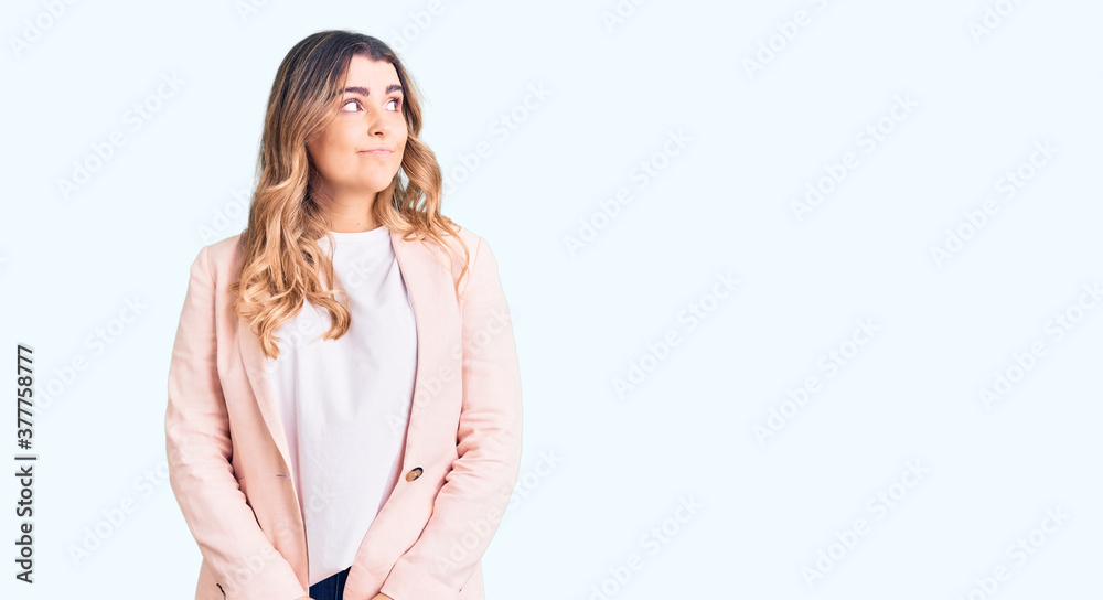 Young caucasian woman wearing business clothes smiling looking to the side and staring away thinking. Young caucasian woman wearing business clothes smiling looking to the side and staring away thinking.