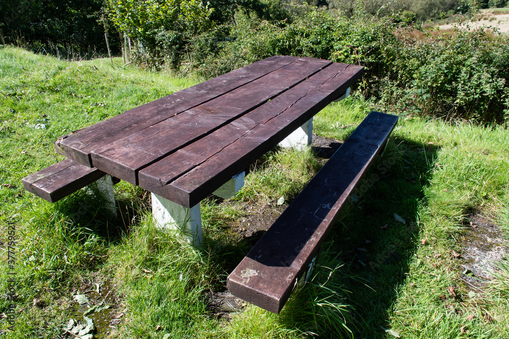 Overhead view of wooden picnic table with two benches in nature. Hiking and adventure. Bench outdoors. Overhead view of wooden picnic table with two benches in nature. Hiking and adventure. Bench outdoors.