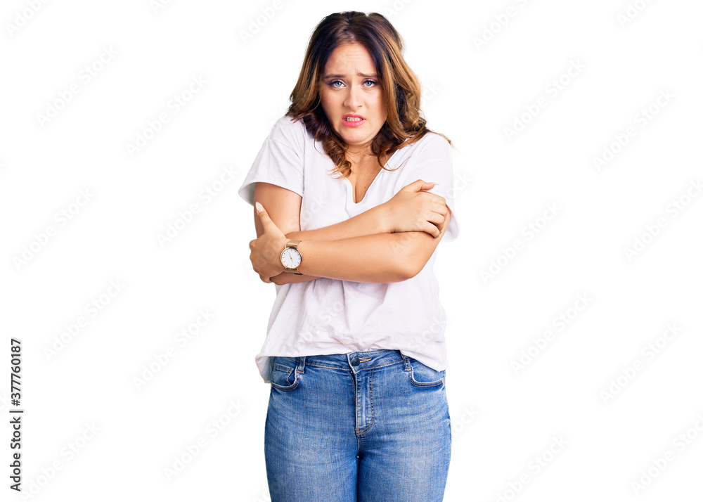 Young beautiful caucasian woman wearing casual white tshirt shaking and freezing for winter cold with sad and shock expression on face Young beautiful caucasian woman wearing casual white tshirt shaking and freezing for winter cold with sad and shock expression on face