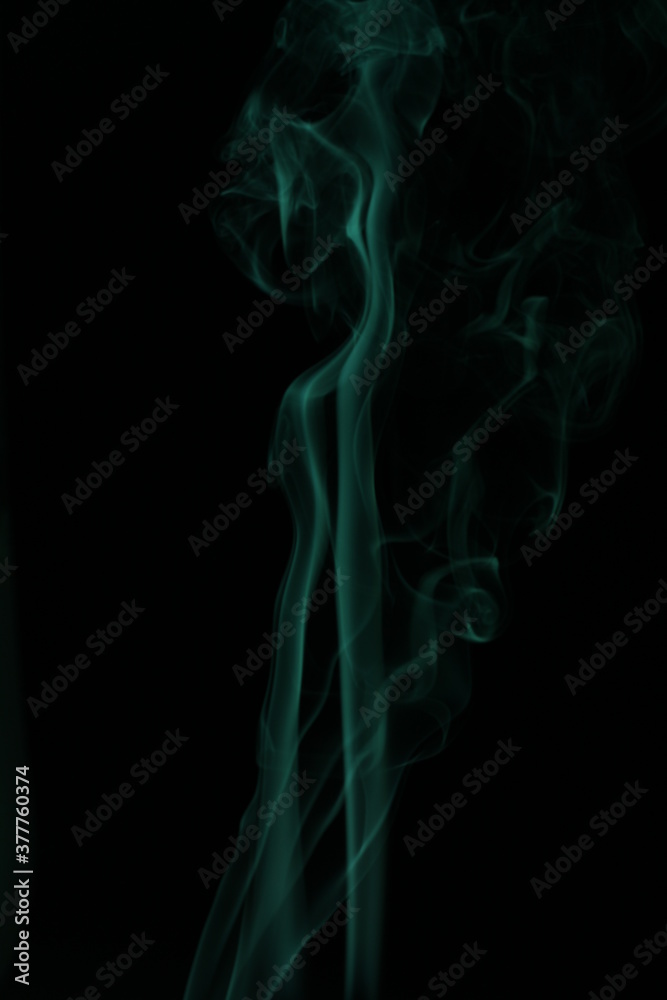 green smoke from incense on a black background green smoke from incense on a black background