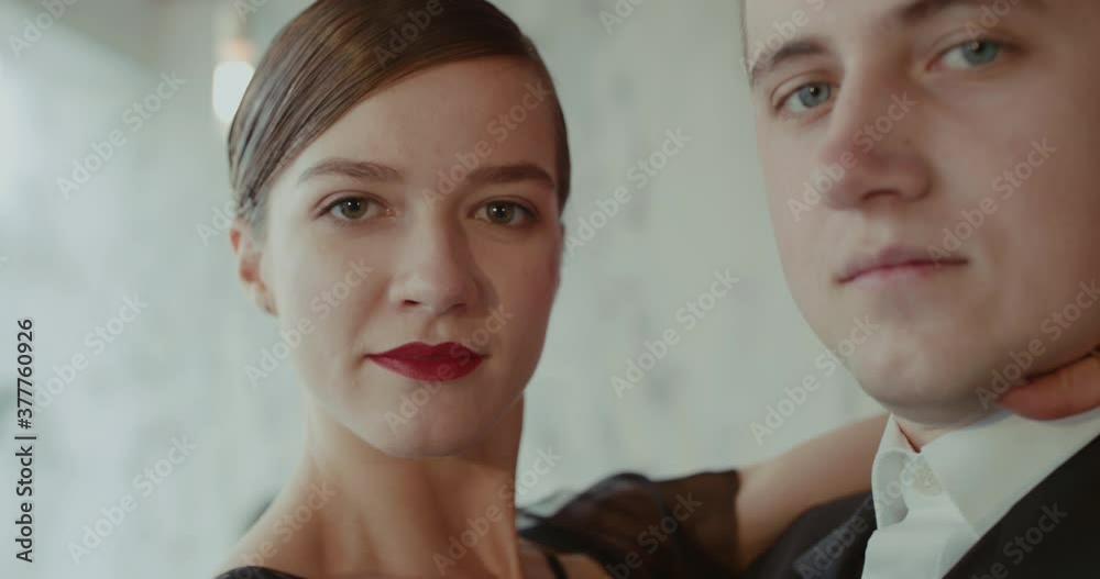 Portrait of couple of dancers turn at camera during perform a ballroom dance Portrait of couple of dancers turn at camera during perform a ballroom dance
