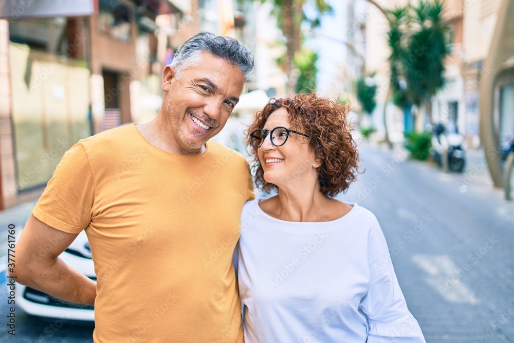 Middle age couple smiling happy standing at street of city. Middle age couple smiling happy standing at street of city.