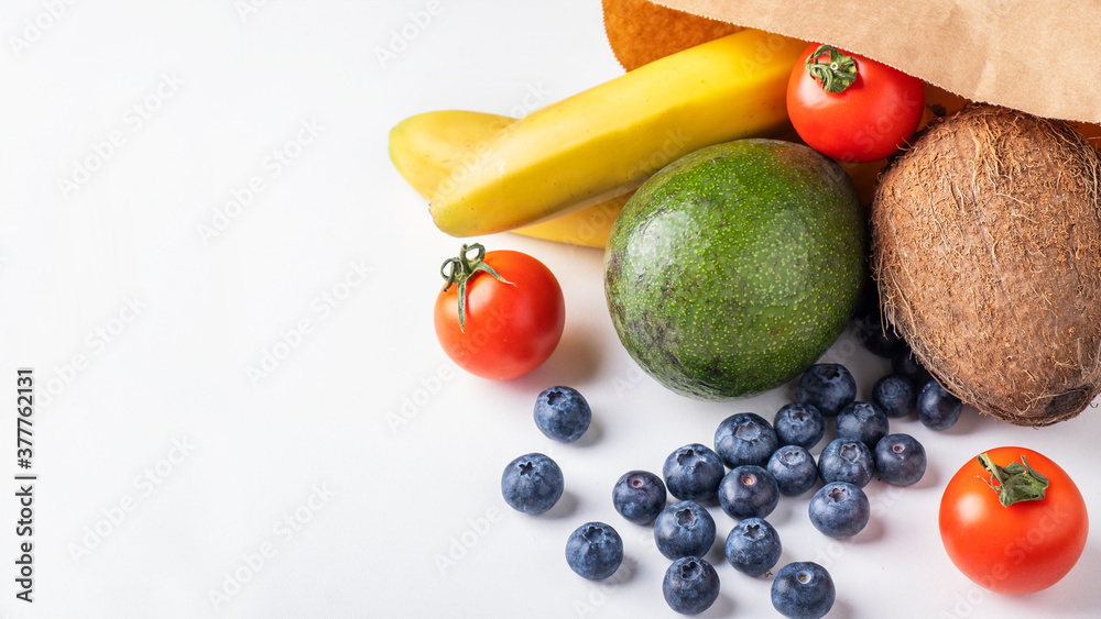 Shop paper bag with fruits and vegetables on white background. Text space Shop paper bag with fruits and vegetables on white background. Text space