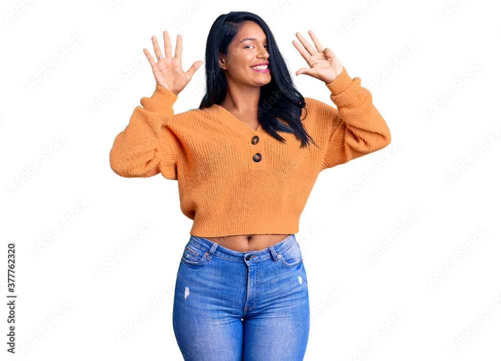 Hispanic woman with long hair wearing casual winter sweater showing and pointing up with fingers number nine while smiling confident and happy. Hispanic woman with long hair wearing casual winter sweater showing and pointing up with fingers number nine while smiling confident and happy.