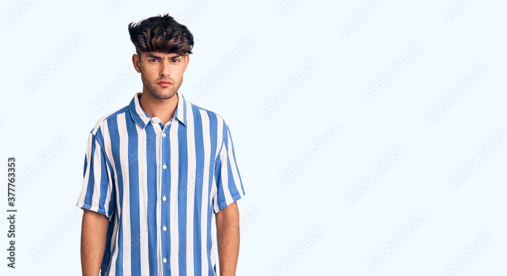 Fototapeta premium Young hispanic man wearing casual clothes skeptic and nervous, frowning upset because of problem. negative person.