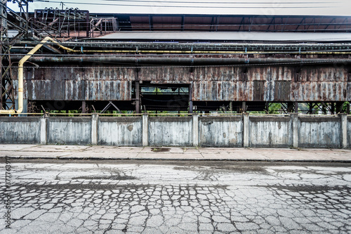 Remnants of an abandoned industrial factory with cracked pavement in the blue collar midwest