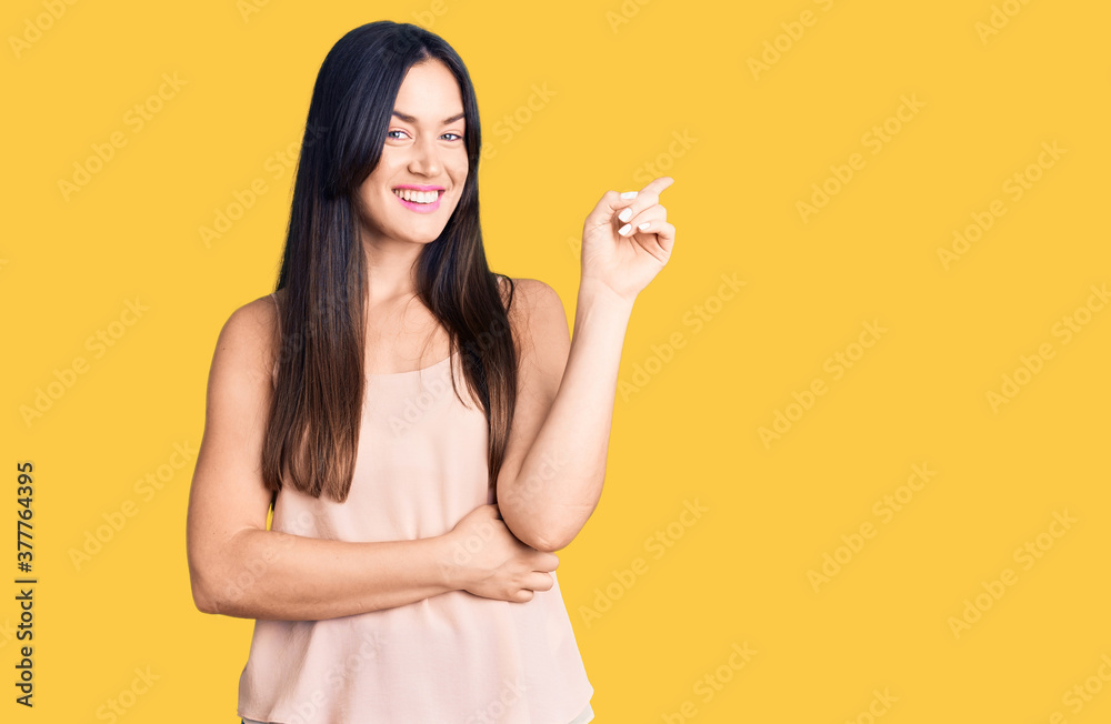 Young beautiful caucasian woman wearing casual clothes smiling happy pointing with hand and finger to the side Young beautiful caucasian woman wearing casual clothes smiling happy pointing with hand and finger to the side