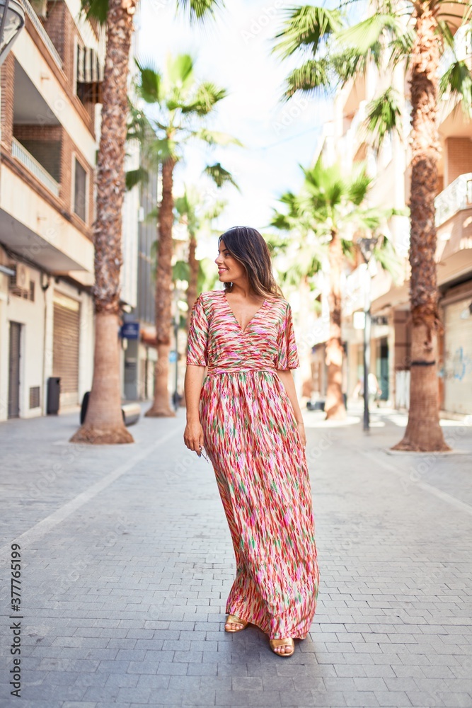 Beautiful young woman wearing fashionable clothes walking down the street Beautiful young woman wearing fashionable clothes walking down the street