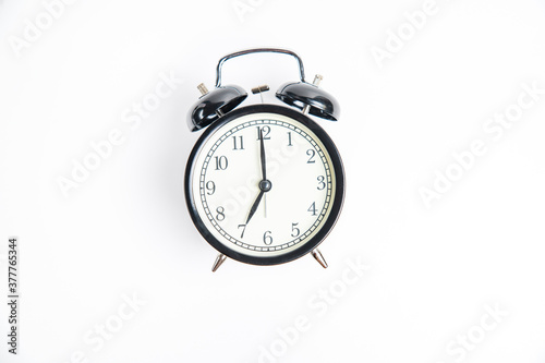 alarm clock on white 7:00