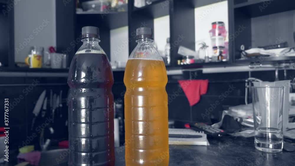plastic bottles with different types of beer. hands put bottles on the table