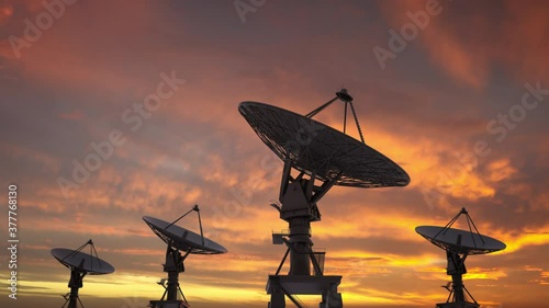 Group of large ground satellites isolated rotating up,  big satellite dish searching the sky during night.