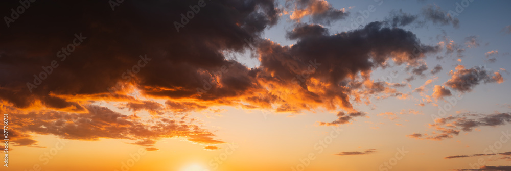 Summer sunset sky high resolution panorama with fleece colorful clouds. Evening dusk good weather natural background.