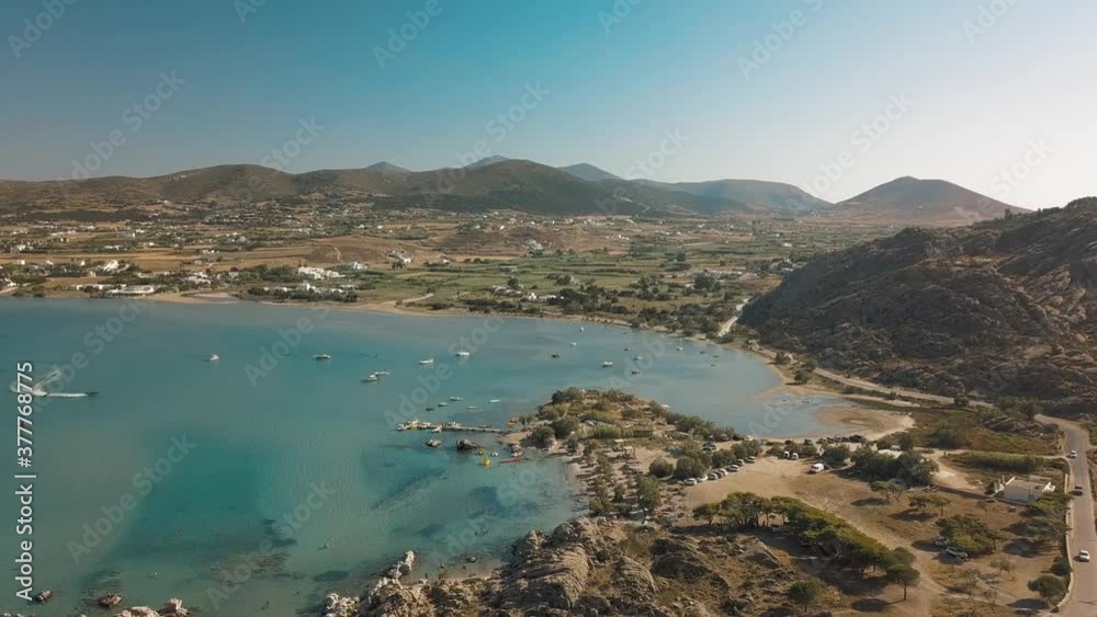 Aerial drone video of sandy beach blue sea water, clear blue sky Paros island Cyclades, Greece Aerial drone video of sandy beach blue sea water, clear blue sky Paros island Cyclades, Greece