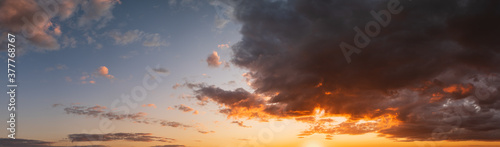 Summer sunset sky high resolution panorama with fleece colorful clouds. Evening dusk good weather natural background.