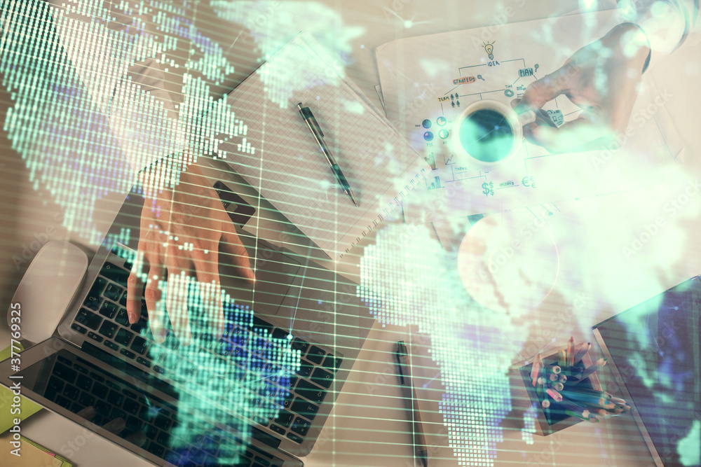 Double exposure of man's hands typing over computer keyboard and business theme hologram drawing. Top view. Financial markets concept. Double exposure of man's hands typing over computer keyboard and business theme hologram drawing. Top view. Financial markets concept.