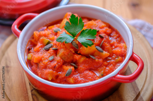 Vegetable stew in a beautiful red saucepan.