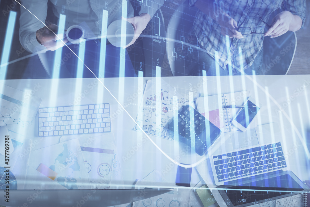 Double exposure of man and woman working together and financial chart hologram drawing. market analysis concept. Computer background. Top View. Double exposure of man and woman working together and financial chart hologram drawing. market analysis concept. Computer background. Top View.