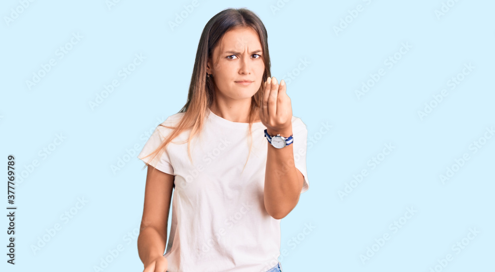 Beautiful caucasian woman wearing casual white tshirt doing italian gesture with hand and fingers confident expression Beautiful caucasian woman wearing casual white tshirt doing italian gesture with hand and fingers confident expression