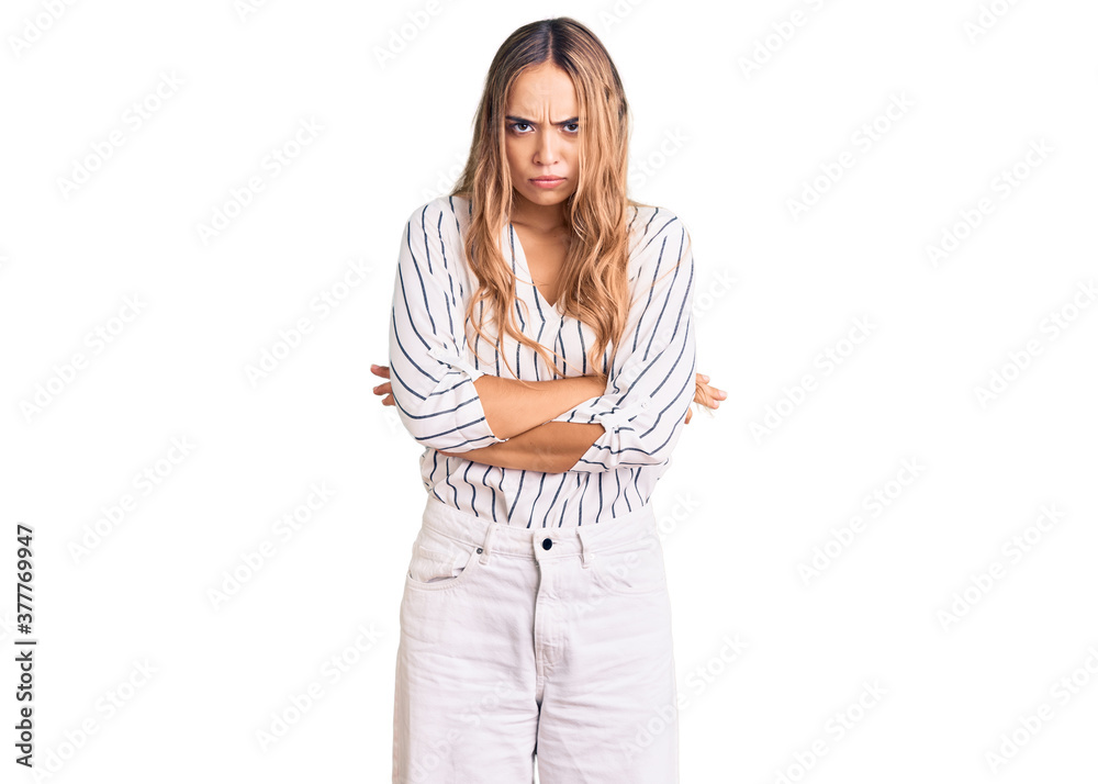 Young beautiful blonde woman wearing casual clothes skeptic and nervous, disapproving expression on face with crossed arms. negative person. Young beautiful blonde woman wearing casual clothes skeptic and nervous, disapproving expression on face with crossed arms. negative person.