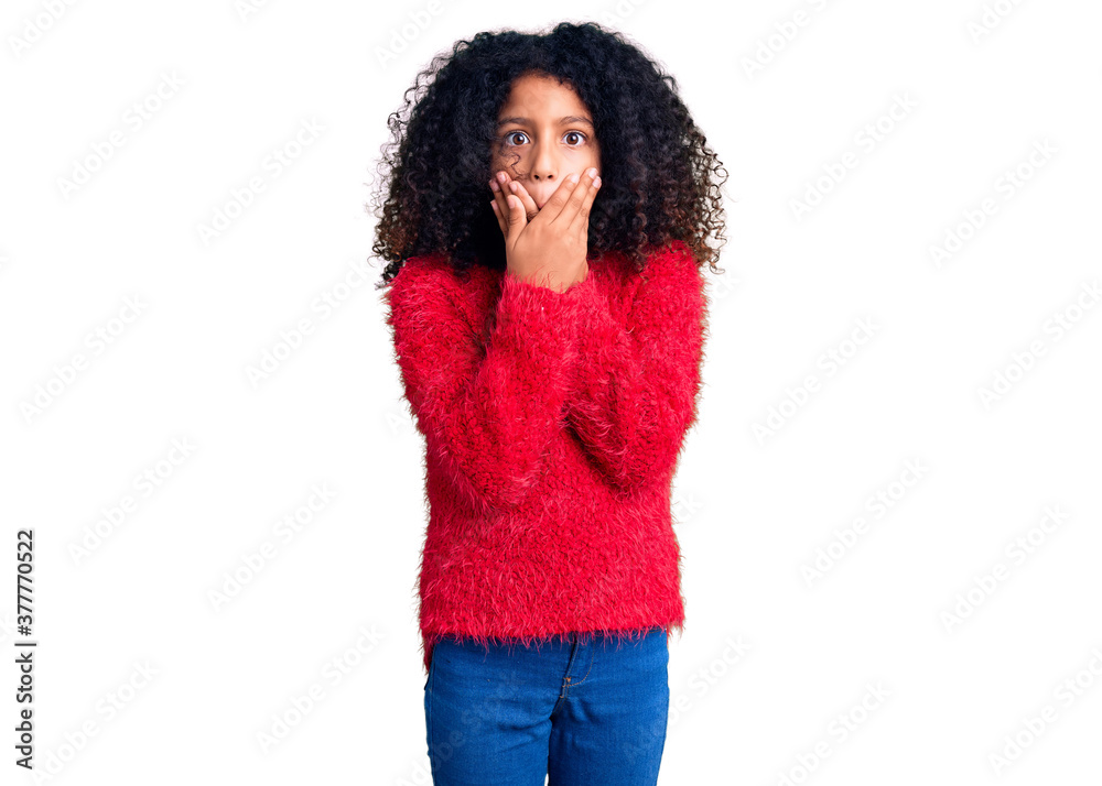 African american child with curly hair wearing casual winter sweater shocked covering mouth with hands for mistake. secret concept. African american child with curly hair wearing casual winter sweater shocked covering mouth with hands for mistake. secret concept.