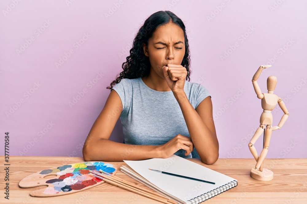 Young african american girl artist sitting at studio table feeling unwell and coughing as symptom for cold or bronchitis. health care concept. - obrazy, fototapety, plakaty 