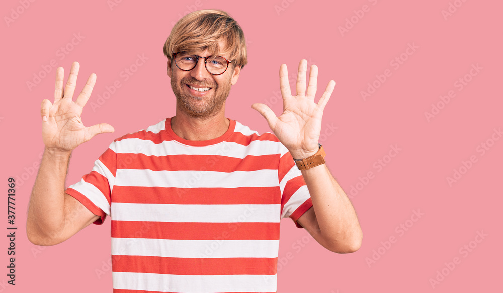Handsome caucasian man with beard wearing casual clothes and glasses showing and pointing up with fingers number nine while smiling confident and happy. Handsome caucasian man with beard wearing casual clothes and glasses showing and pointing up with fingers number nine while smiling confident and happy.