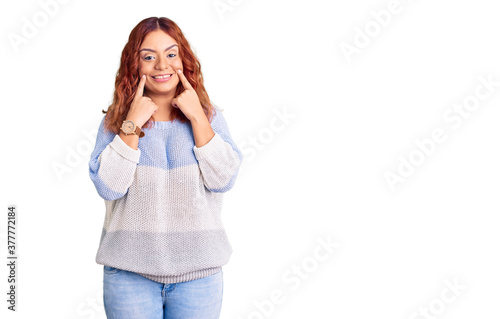 Young latin woman wearing casual clothes smiling with open mouth, fingers pointing and forcing cheerful smile