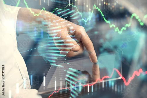 Wallpaper Mural Double exposure of man's hands holding and using a digital device and forex graph drawing. Financial market concept. Torontodigital.ca
