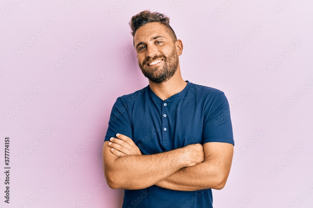 Handsome man with beard wearing casual clothes happy face smiling with crossed arms looking at the camera. positive person. Handsome man with beard wearing casual clothes happy face smiling with crossed arms looking at the camera. positive person.