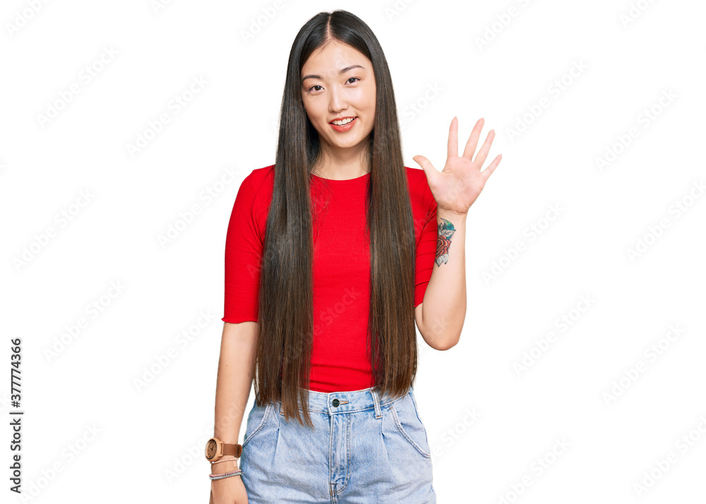 Young chinese woman wearing casual clothes showing and pointing up with fingers number five while smiling confident and happy. Young chinese woman wearing casual clothes showing and pointing up with fingers number five while smiling confident and happy.