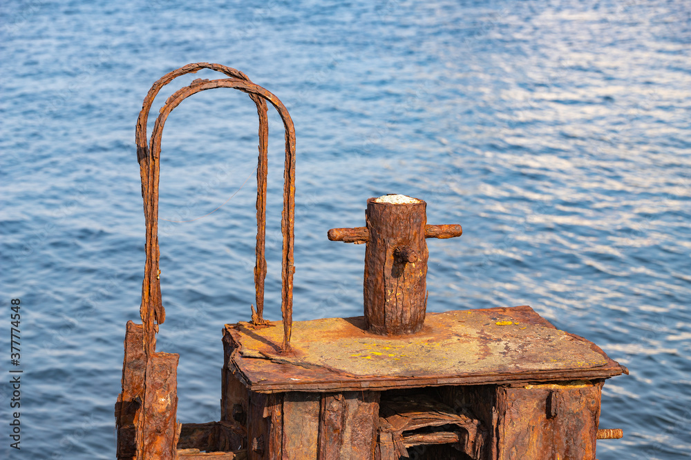 Fotografie Old rusty bollard in the seaport
