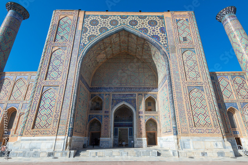 Ulugh Beg Madrasah and its two minarets with ceramic tiles in Persian style. Registan, Samarkand, Uzbekistan. Islamic architecture.