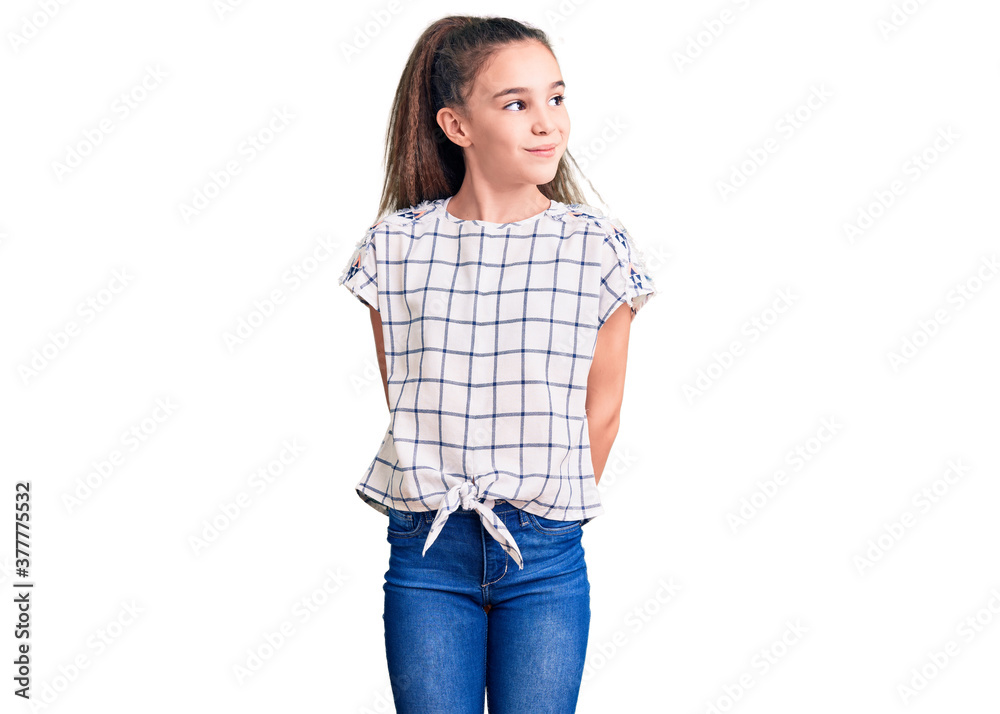 Cute hispanic child girl wearing casual clothes smiling looking to the side and staring away thinking. Cute hispanic child girl wearing casual clothes smiling looking to the side and staring away thinking.