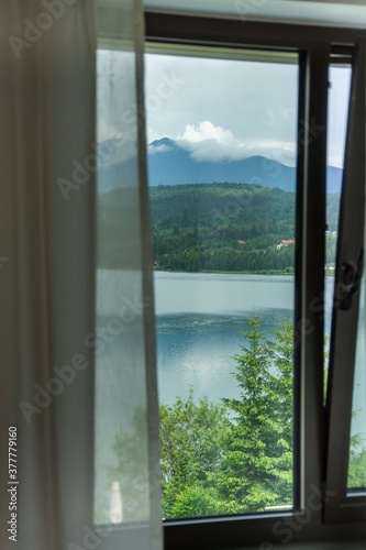 Bistrita, ROMANIA, 2020, View of Colibita Lake through the window © Laurenx