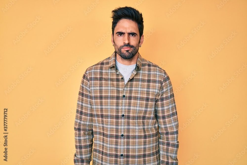 Handsome hispanic man with beard wearing casual clothes skeptic and nervous, frowning upset because of problem. negative person.
