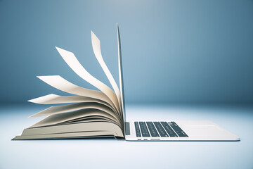 Abstract book and open laptop.