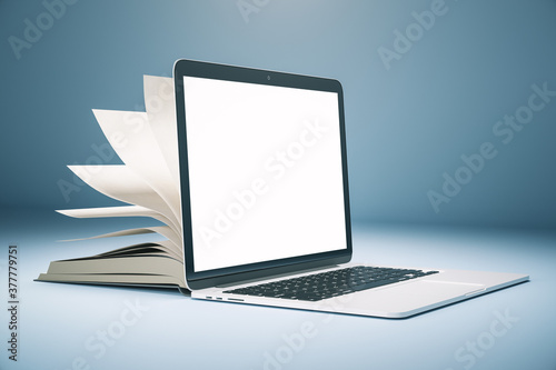 Creative open book computer on subtle background with copy space.
