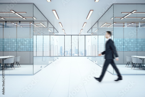 Businessman walking in meeting room interior