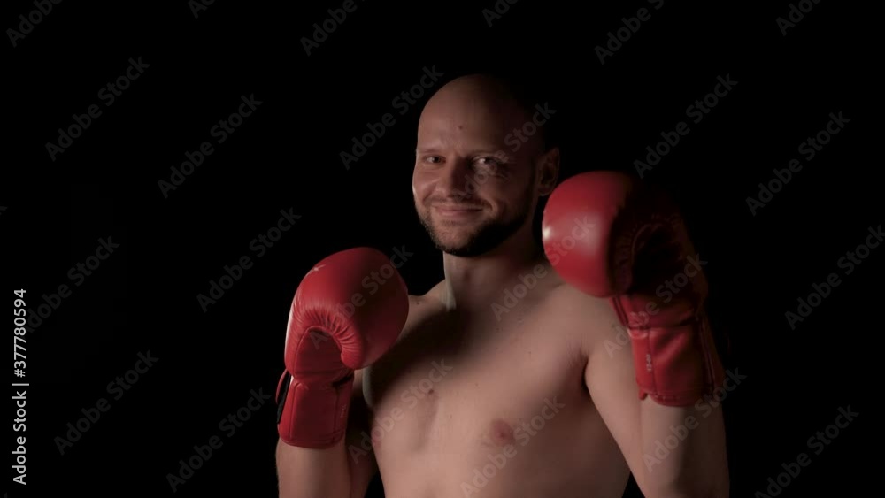 The male boxer raises his hands jokingly and smiles The male boxer raises his hands jokingly and smiles