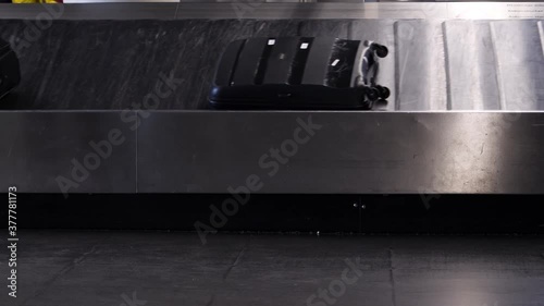 suitcases motion with no people on the moving airport conveyor belt line