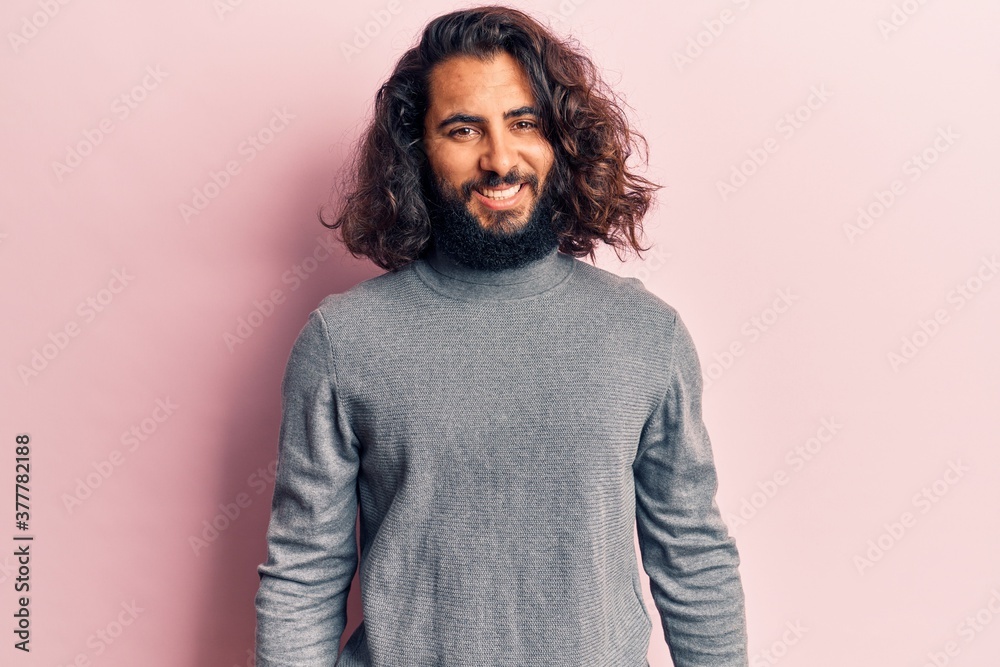 Young arab man wearing casual clothes with a happy and cool smile on face. lucky person. Young arab man wearing casual clothes with a happy and cool smile on face. lucky person.