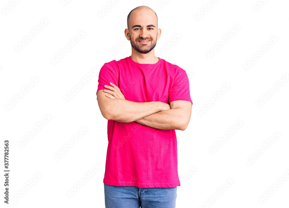 Young handsome man wearing casual t shirt happy face smiling with crossed arms looking at the camera. positive person.