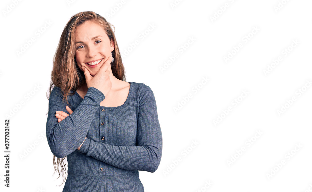 Young beautiful blonde woman wearing casual dress looking confident at the camera smiling with crossed arms and hand raised on chin. thinking positive. Young beautiful blonde woman wearing casual dress looking confident at the camera smiling with crossed arms and hand raised on chin. thinking positive.