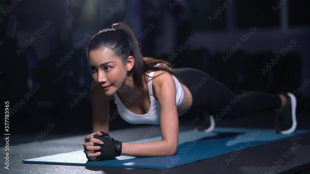 Fitness beautiful asian woman doing plank exercise workout in gym 4k resolution