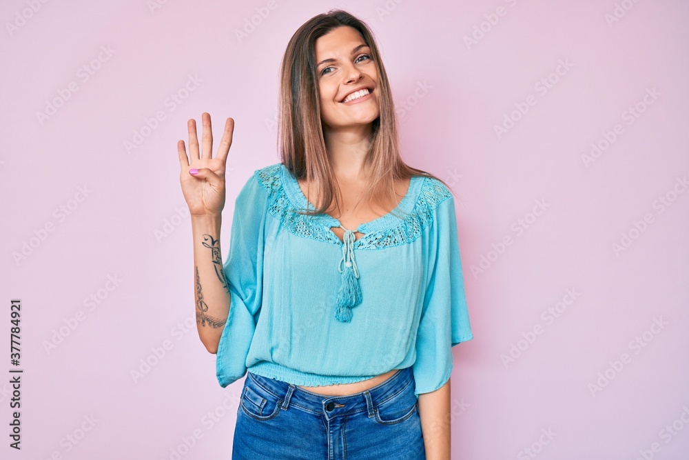 Beautiful caucasian woman wearing casual clothes showing and pointing up with fingers number four while smiling confident and happy.