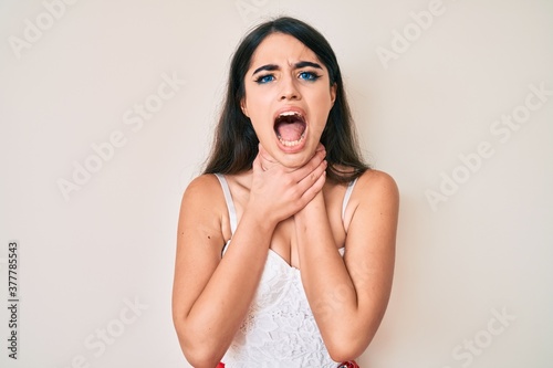 Brunette teenager girl posing elegant shouting and suffocate because painful strangle. health problem. asphyxiate and suicide concept.