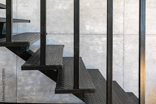 Slika na platnu Loft minimal interior with metallic staircase on the background of gray cement wall