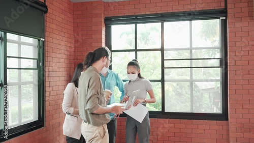 Multi ethnic business people in face mask meeting new normal in office